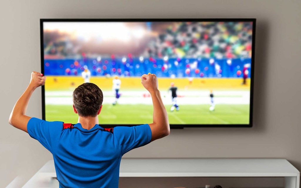 Man-Watching-Satellite-TV-enjoying-Sports-1024x640